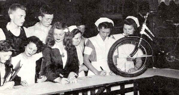 Hoping for the shiny bike are Marion Taylor, Florence Newell, Anna Mae Fisher, Dorothy Brizendine, Josephine La Placca and Ruth Townsley. Behind them are Wesley McDowell and Jim Glenney.  Photo from The Delaware County Advocate - June 1942