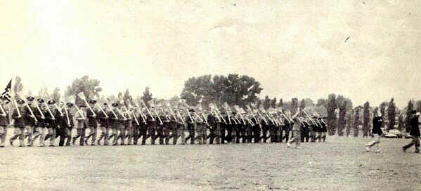 P. M. C. alumni perform the traditional broom drill before the reviewing stand. - Photo from The Delaware County Advocate, June 1942